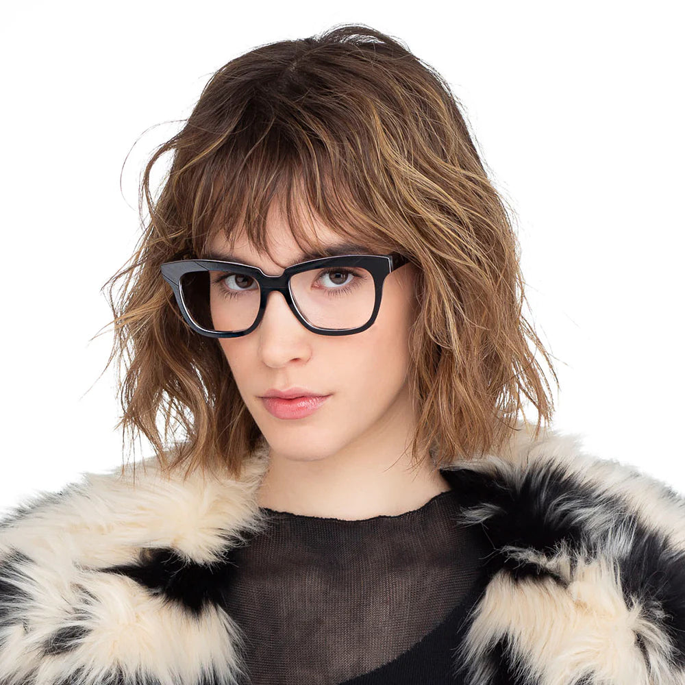 Eyeglasses with a grooved veneer pattern, predominantly in black color with metal hinges.