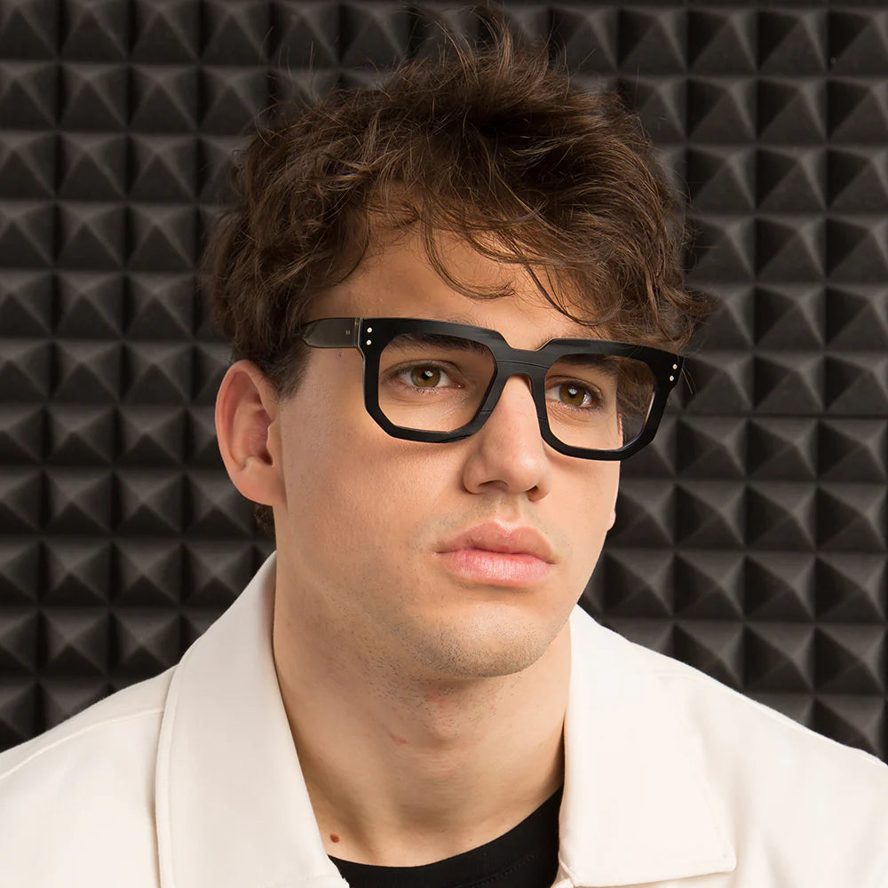 A pair of black, angular, square-shaped eyeglasses with a vinyl exterior 