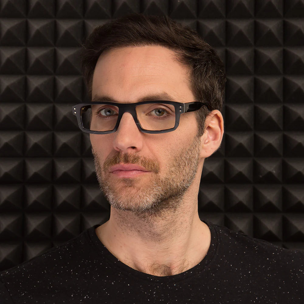 A pair of black rectangular sunglasses with a pattern that resembles a vinyl record texture.