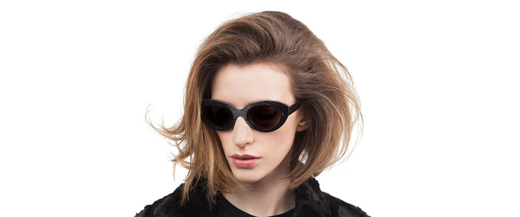 Black oval-shaped sunglasses with a record-inspired exterior.