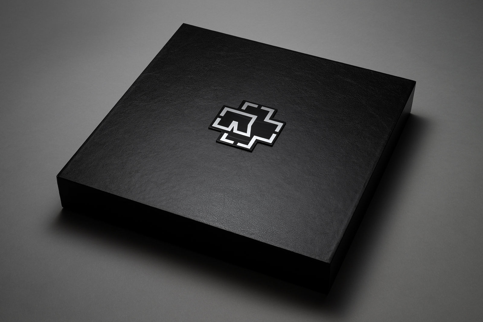 Black box with a silver logo on a black background