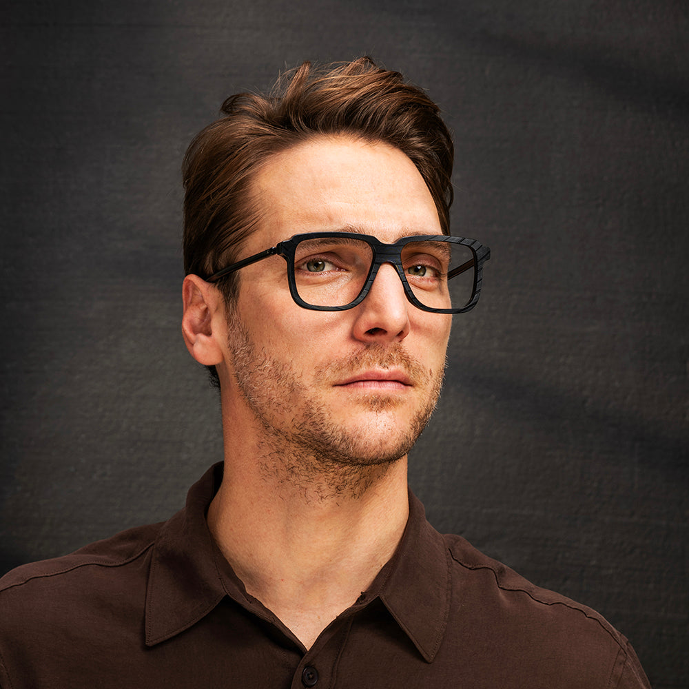 Deacon features large lenses, dropped temples and bridge. Queen's bassist really held things together. Temples are made from upcycled bicycle brake cables.